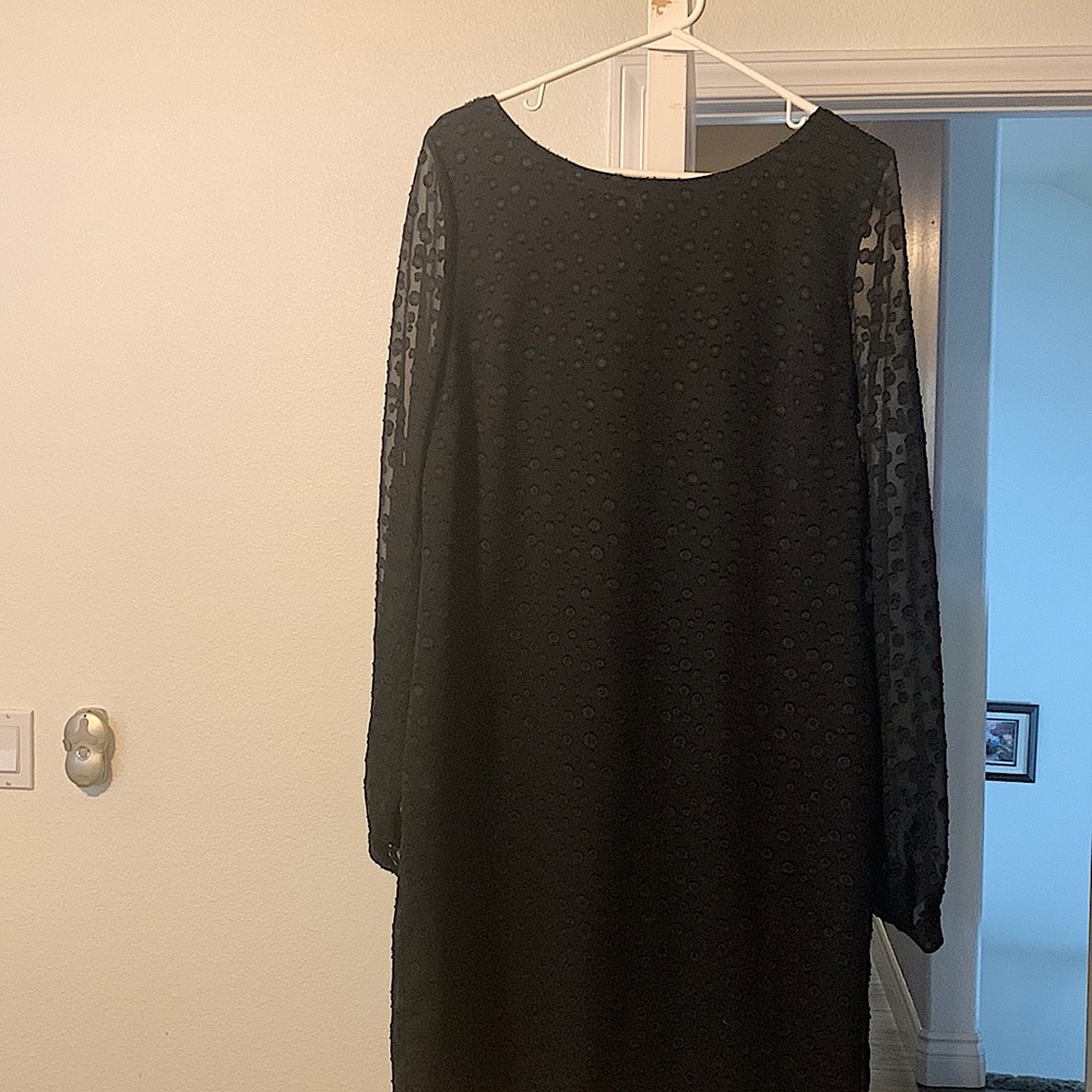 Black dress with sheer sleeves.